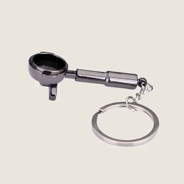 A sleek black portafilter keychain with a spouted design, crafted for coffee lovers and baristas who appreciate espresso-making essentials.
