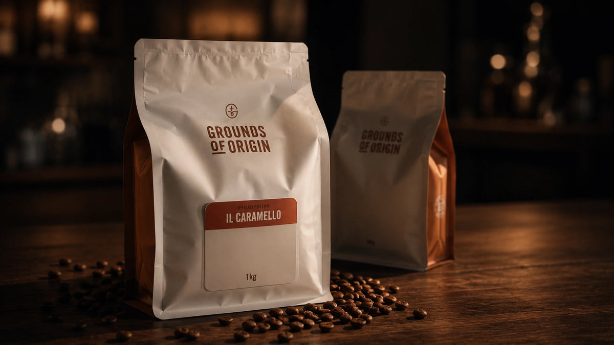 Two coffee bags labeled 'Grounds of Origin' on a wooden surface with scattered coffee beans.