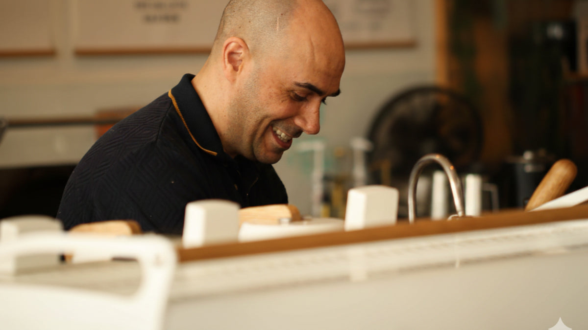 Ryde Jeavons the coffee coach making coffee behind a coffee machine in his cafe. 