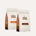 Two 'Grounds of Origin' coffee bags on a white background