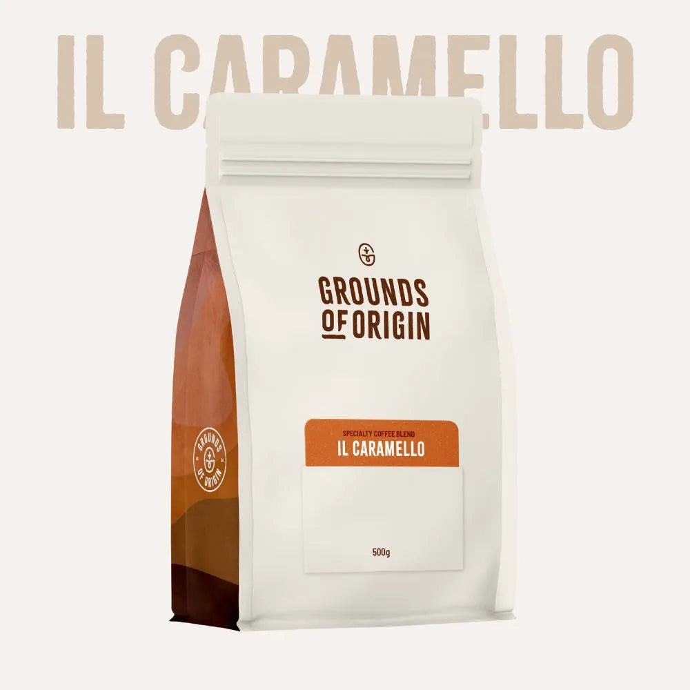 Coffee bag labeled 'IL Caramello' from 'Grounds of Origin' on a white background