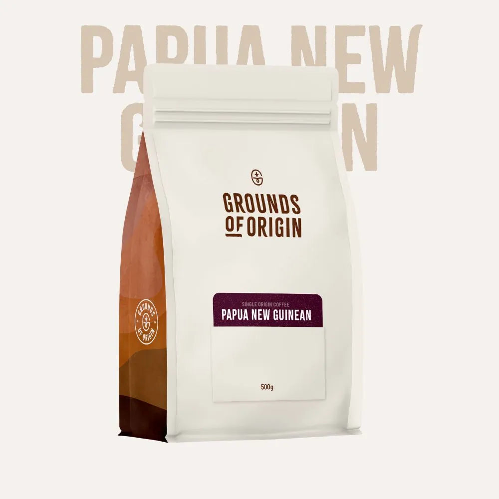 Coffee bag labeled 'Grounds of Origin Papua New Guinean' on a white background